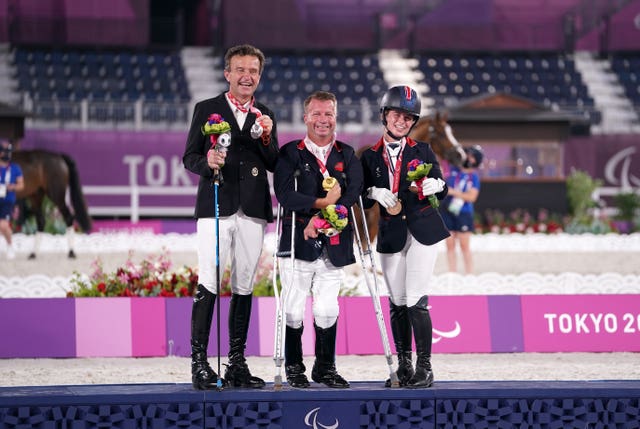 Sir Lee Pearson (centre) with his gold medal after winning the dressage individual (grade two) alongside second-placed Austria's Pepo Such and third placed ParalympicsGB team-mate Georgia Wilson