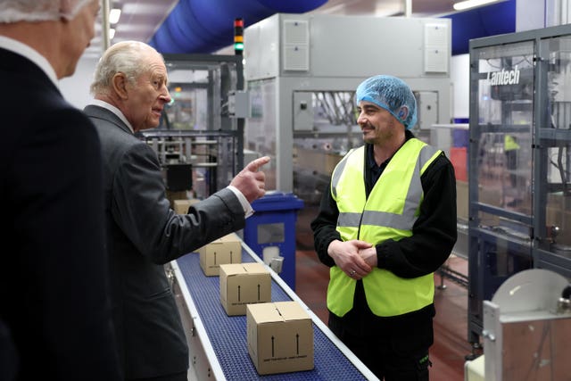 The King meets a member of staff during a visit to view the Coronation Food Project at the Greencore food manufacturing site in Warrington