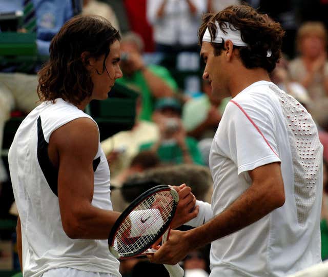 Federer shakes hands with Nadal after seeing off the Spaniard in four sets to secure a fourth straight Wimbledon title 