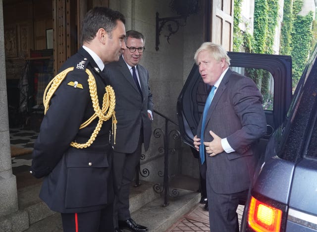 Boris Johnson is greeted by the then Queen Elizabeth II’s Equerry Lieutenant Colonel Tom White and her private Secretary Sir Edward Young as he arrives at Balmoral for an audience to formally resign (Andrew Milligan/PA)