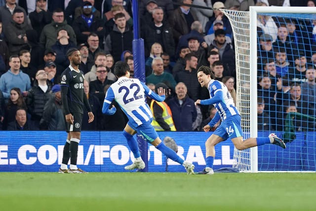 Chelsea's Jorrel Hato, left, looks on as Ferdi Kadioglu, right, celebrates after scoring Brighton’s first goal