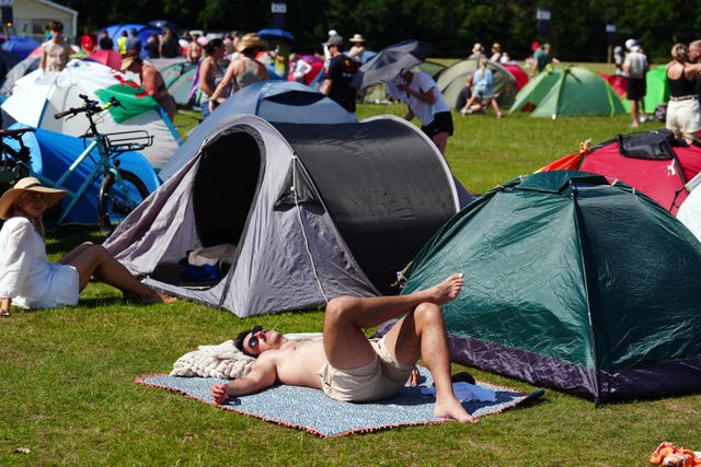 A fan sunbathes in the queue