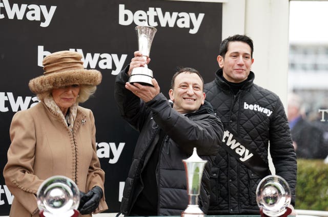 Tony Bloom, alongside the Queen, after being presented with the trophy following victory in the Queen Mother Champion Chase with Energumene 