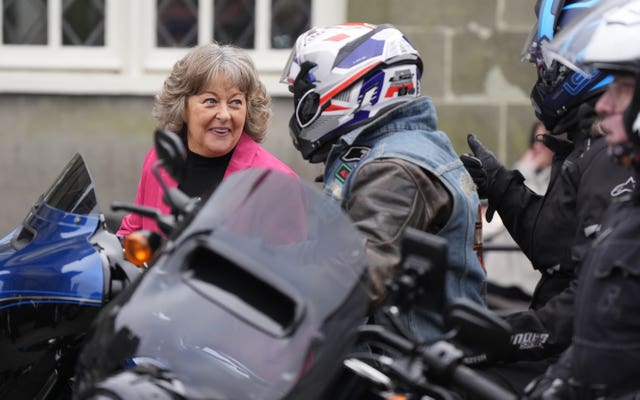 Tiggy Walker (left) chats with Harley Davidson riders who are escorting her husbands hearse in tribute