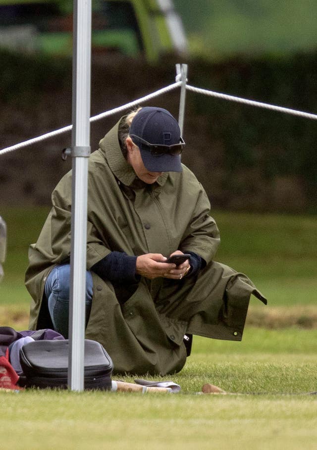 Zara Tindall reads her phone (Steve Parsons/PA)