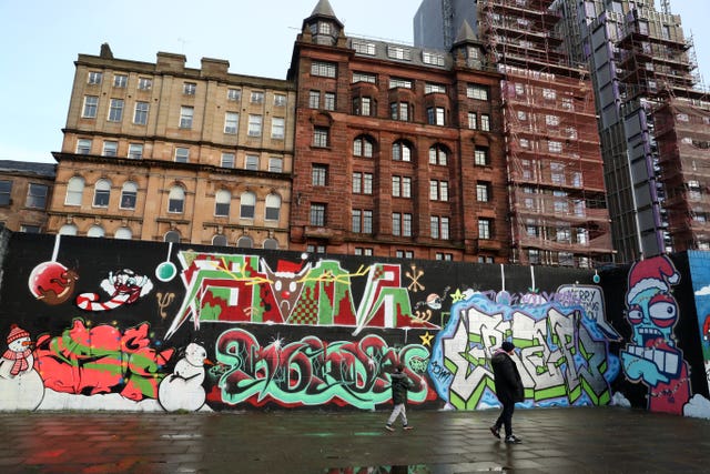 Members of the public view graffiti in Glasgow, Scotland (Andrew Milligan/PA)