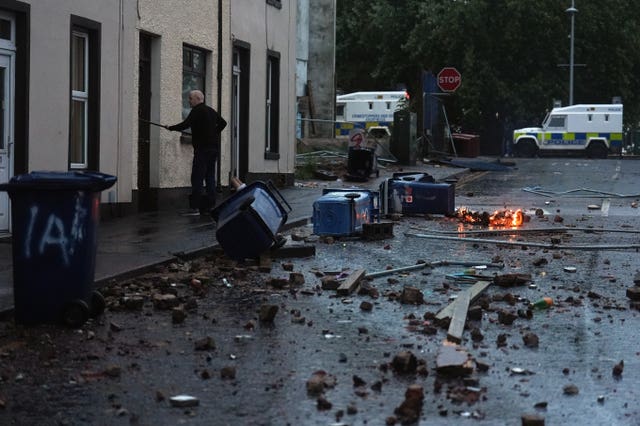 A resident clearing debris in Portadown
