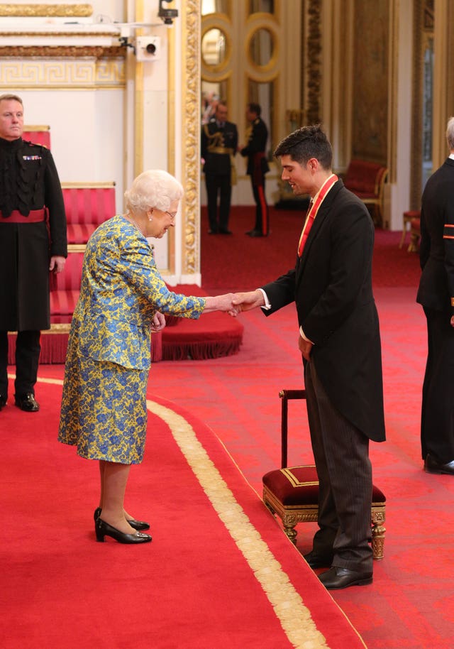 Sir Alastair Cook receives a knighthood for services to cricket from the Queen during an investiture ceremony at Buckingham Palace
