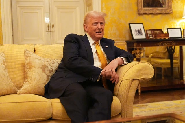 Donald Trump sits on a sofa in the residence of the UK ambassador to France