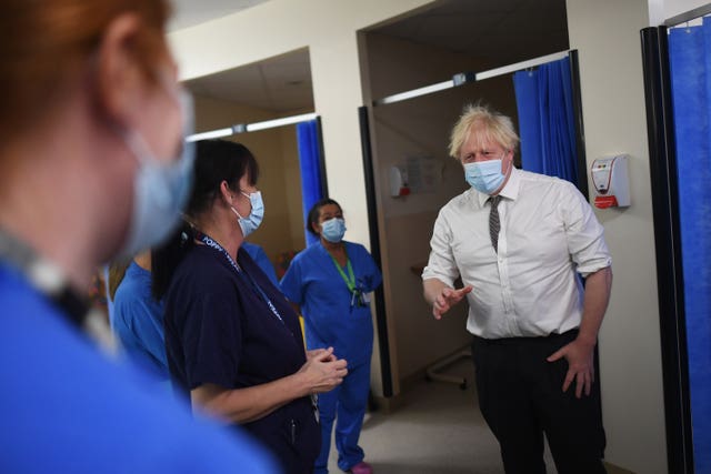 Boris Johnson was photographed with and without a face mask on during his hospital visit on Monday