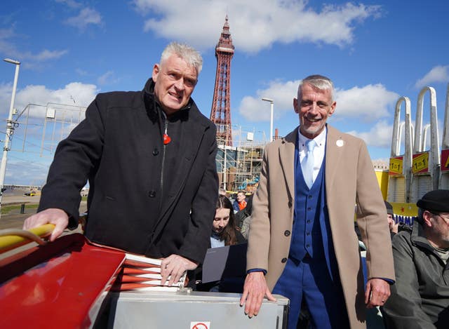 Lee Anderson, left, and Mark Butcher travel through Blackpool on an open top bus during a campaign event