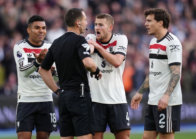 Manchester United’s Matthijs de Ligt (centre right) protests to referee David Coote