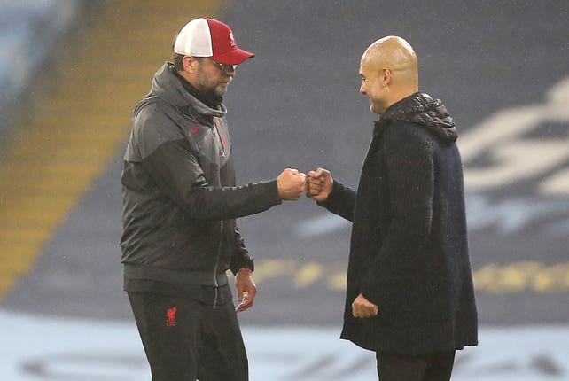 Liverpool manager Jurgen Klopp (left) and Manchester City manager Pep Guardiola saw their sides play out an entertaining 1-1 draw