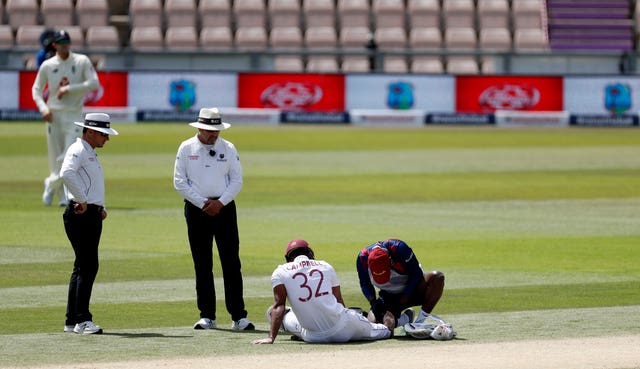West Indies' John Campbell receives medical treatment prior to retiring injured 
