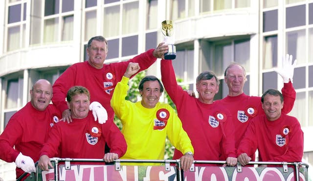 Seven of England’s victorious 1966 World Cup winning team celebrate with a replica Jules Rimet trophy