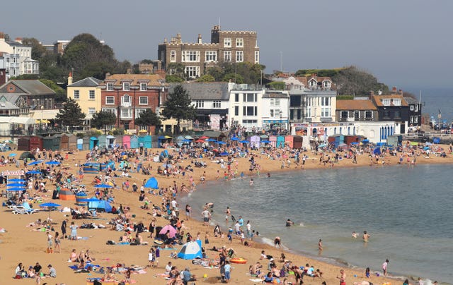 People enjoy the bank holiday sunshine on the beach in Broadstairs, Kent 