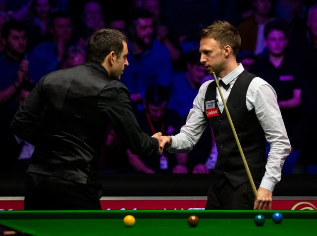 Judd Trump shakes hands with Ronnie O’Sullivan (left) after winning the Masters final (Steven Paston/PA).