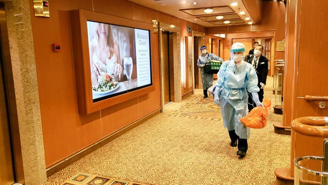 People wear protective clothing on board the Diamond Princess cruise ship (@daxa_tw/PA Wire)