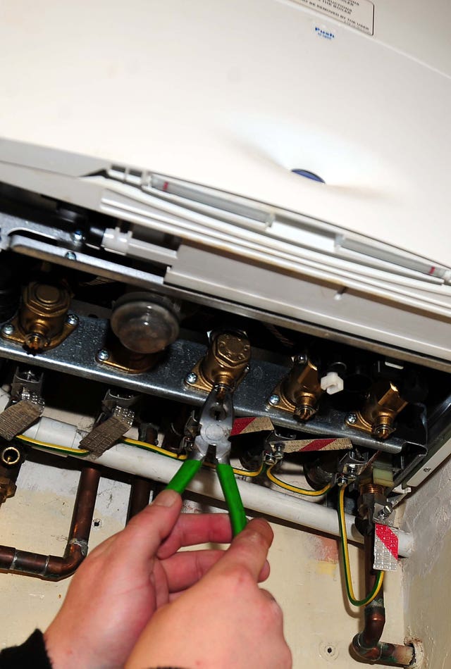 A plumber working on a gas boiler