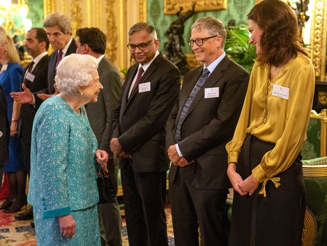 The Queen greets Bill Gates at a reception for international business and investment leaders at Windsor Castle to mark the Global Investment Summit