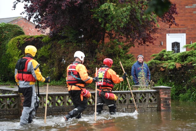 Rescue workers in Wainfleet All Saints, in Lincolnshire, where streets and properties are flooded after the town had more than two months of rain in just two days