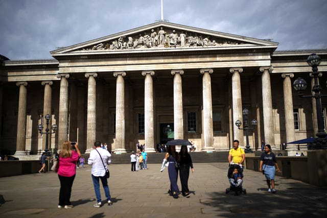 Tourists mill about in front of the entrance to the British Museum