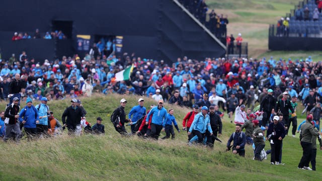 Fans rush on to the course 