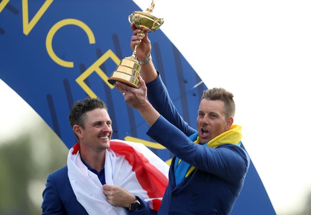 Henrik Stenson lifts the Ryder Cup with team-mate Justin Rose