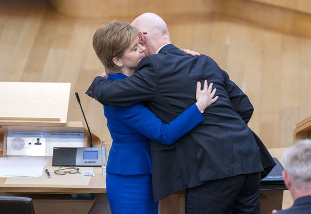 Nicola Sturgeon and John Swinney embracing in the Holyrood chamber