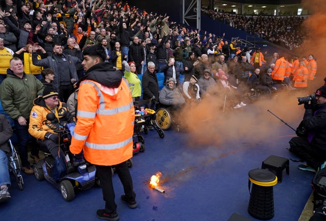 A smoke flare on the ground in front of the Wolves fans