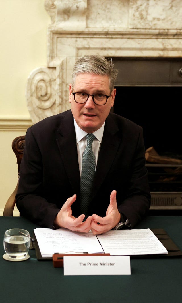 Prime Minister Sir Keir Starmer sits at a table in 10 Downing Street