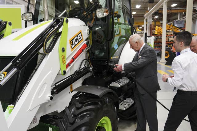 The King Charles being shown how to refuel an engine