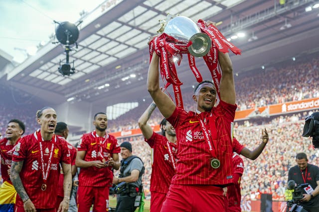 Liverpool’s Trent Alexander-Arnold celebrates with the Premier League trophy after the Premier League match at Anfield, Liverpool