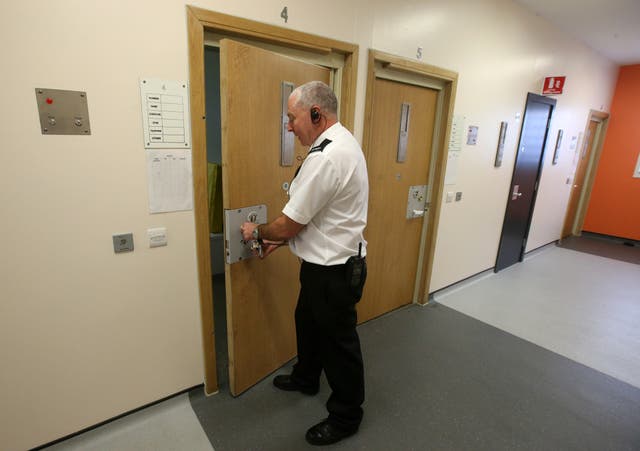 Prison officer Colin Roberston locks a separation cell in the Dumyat Wing during a visit to HMP&YOI Cornton Vale in Stirling