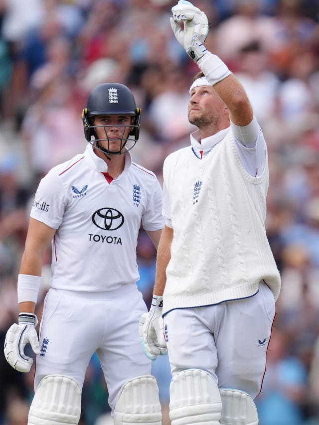 Joe Root, right, points to the sky while wearing a white headband in tribute to the late Graham Thorpe after reaching his century against India at the Oval