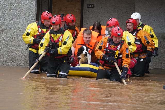 Members of the emergency services help local residents to safety in Brechin