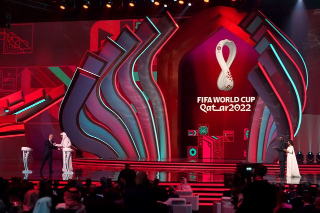 FIFA president Gianni Infantino and Qatar Emir Tamim bin Hamad Al Thani shake hands during the FIFA World Cup Qatar 2022 Draw at the Doha Exhibition and Convention Centre
