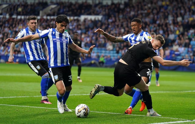 Sheffield Wednesday’s Reece James (left) and Liam Palmer battle for the ball with Peterborough United’s Jack Taylor during the Sky Bet League One play-off semi-final second leg match at Hillsborough, Sheffield