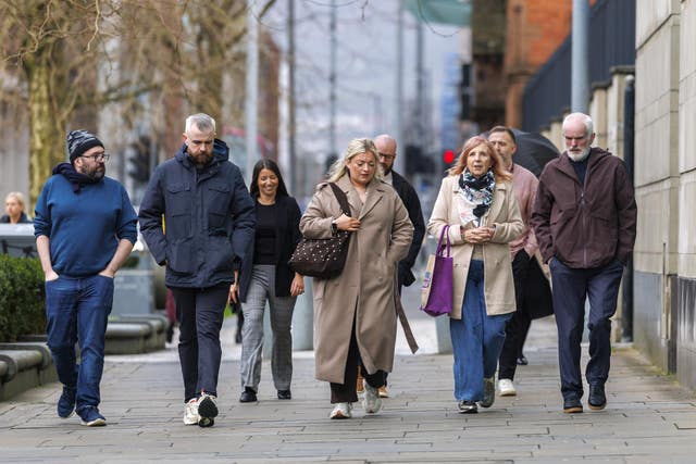 Several members of Natalie McNally's family walking in a line outside