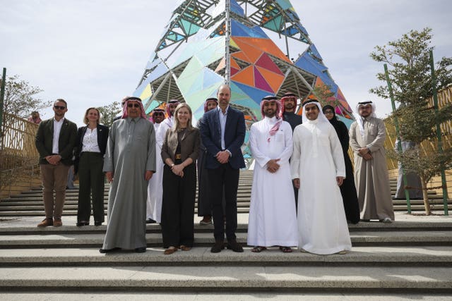 The Prince of Wales stands for a photo near the Art Tower during a visit to an environmentally sustainable urban regeneration programme at Sports Boulevard in Riyadh