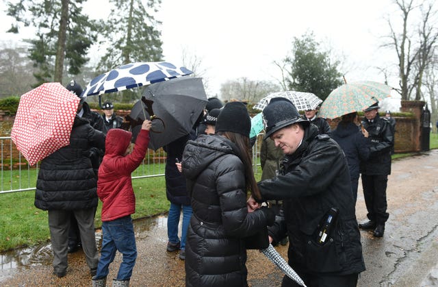 Police search members of the crowd