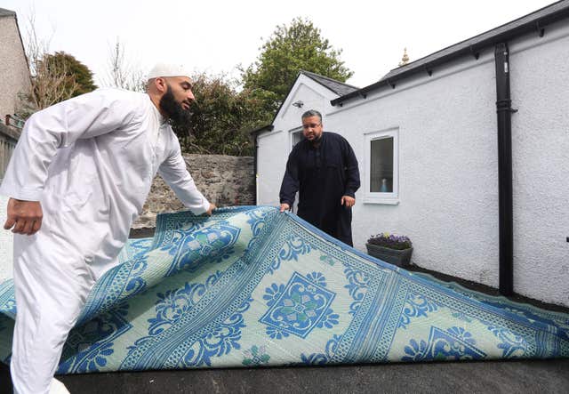 Members of the Muslim community in Stornoway on the Isle of Lewis put down a prayer mat outside (Andrew Milligan/PA)