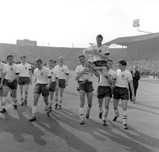 Jimmy Armfield, second from right, helps lift England captain Johnny Haynes after a 9-3 win against Scotland at Wembley secured the Home Nations championship in 1961 