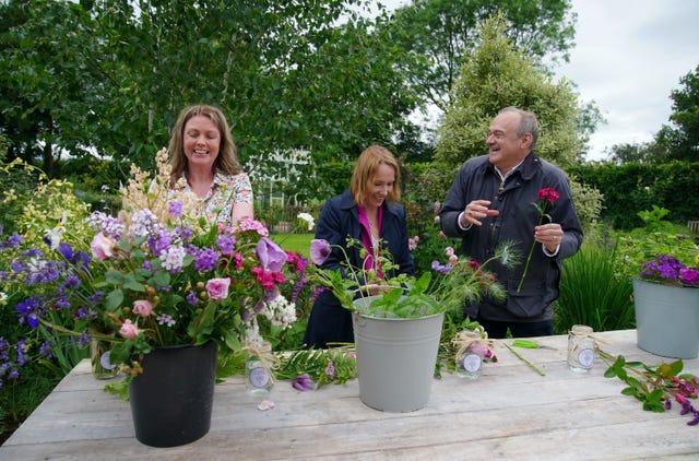 Vicky Gilbert of Shropshire Flower Farm, left to right, Liberal Democrat candidate for North Shropshire Helen Morgan and Liberal Democrat leader Sir Ed Davey make flower bouquets picked from the wild garden at Shropshire Flower Farm, during a visit to Whitchurch, Shropshire 