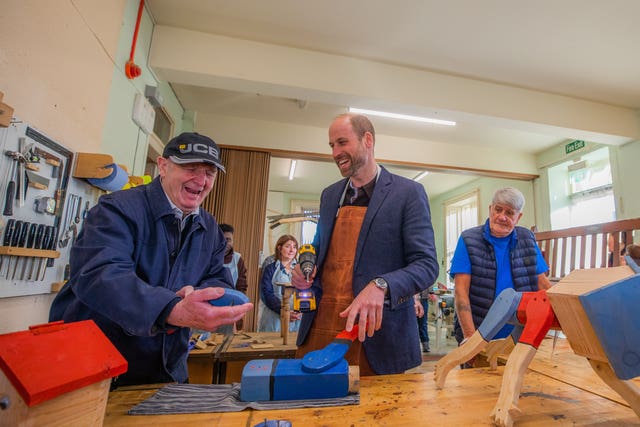 The Prince of Wales, known as the Duke of Rothesay when in Scotland, laughs during a visit to a workshop at Carnoustie and Monifieth Men’s Shed in Angus 