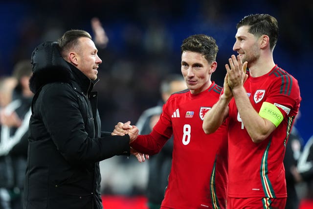 Craig Bellamy embraces Harry Wilson and Ben Davies