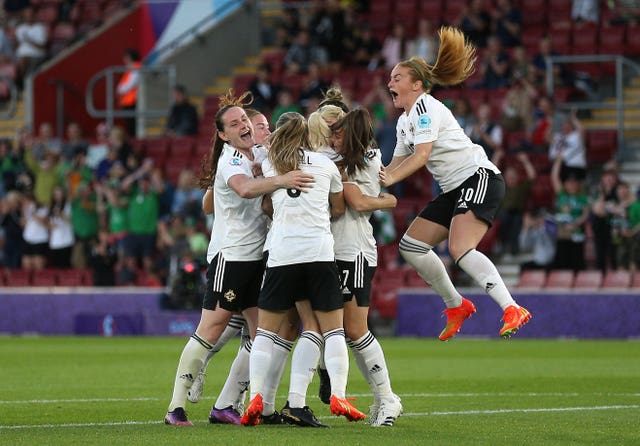 Northern Ireland’s Julie Nelson is mobbed by team-mates after scoring