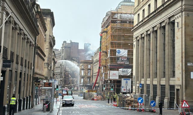 Firefighters damp down the remains of the fire