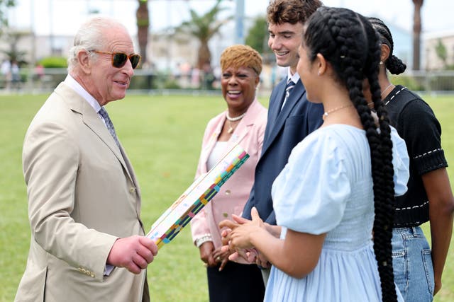 The King speaks to the winner of the Commonwealth Baton Relay design competition