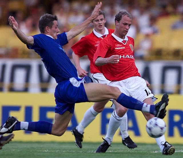 Jordi Cruyff attempts a cross with ole Gunnar Solskjaer looking on in the background